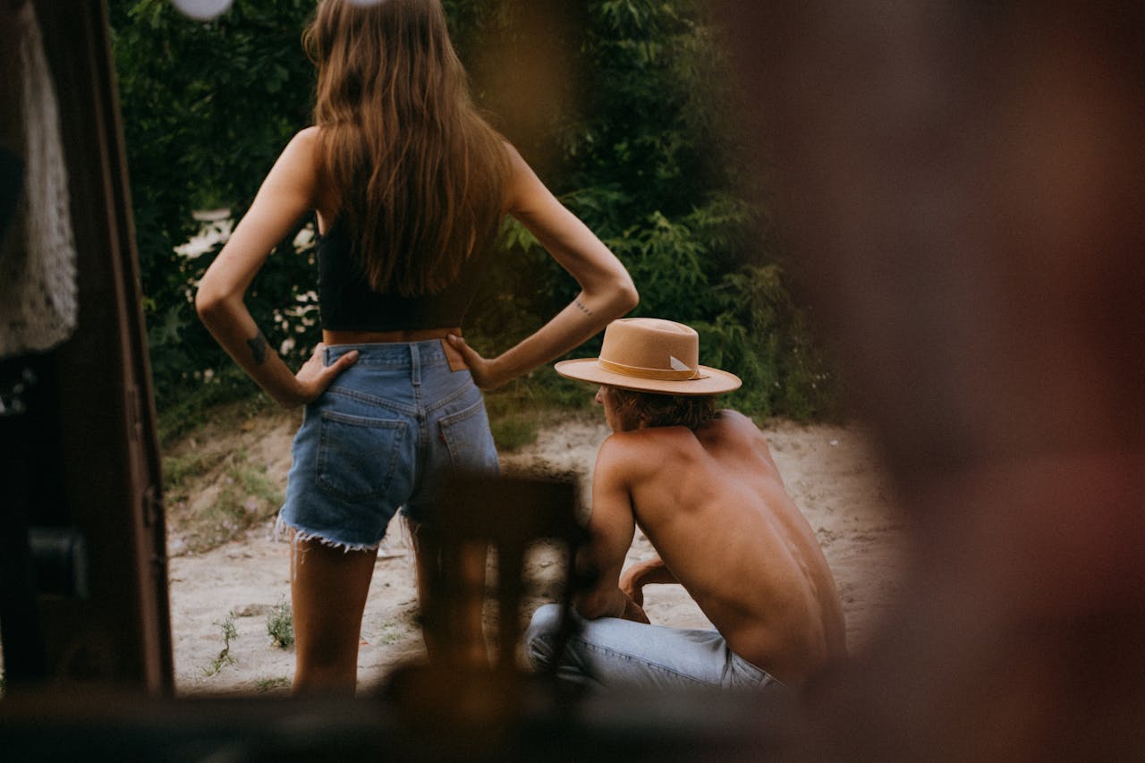Two people enjoy a relaxing summer day outdoors, captured in a candid moment.